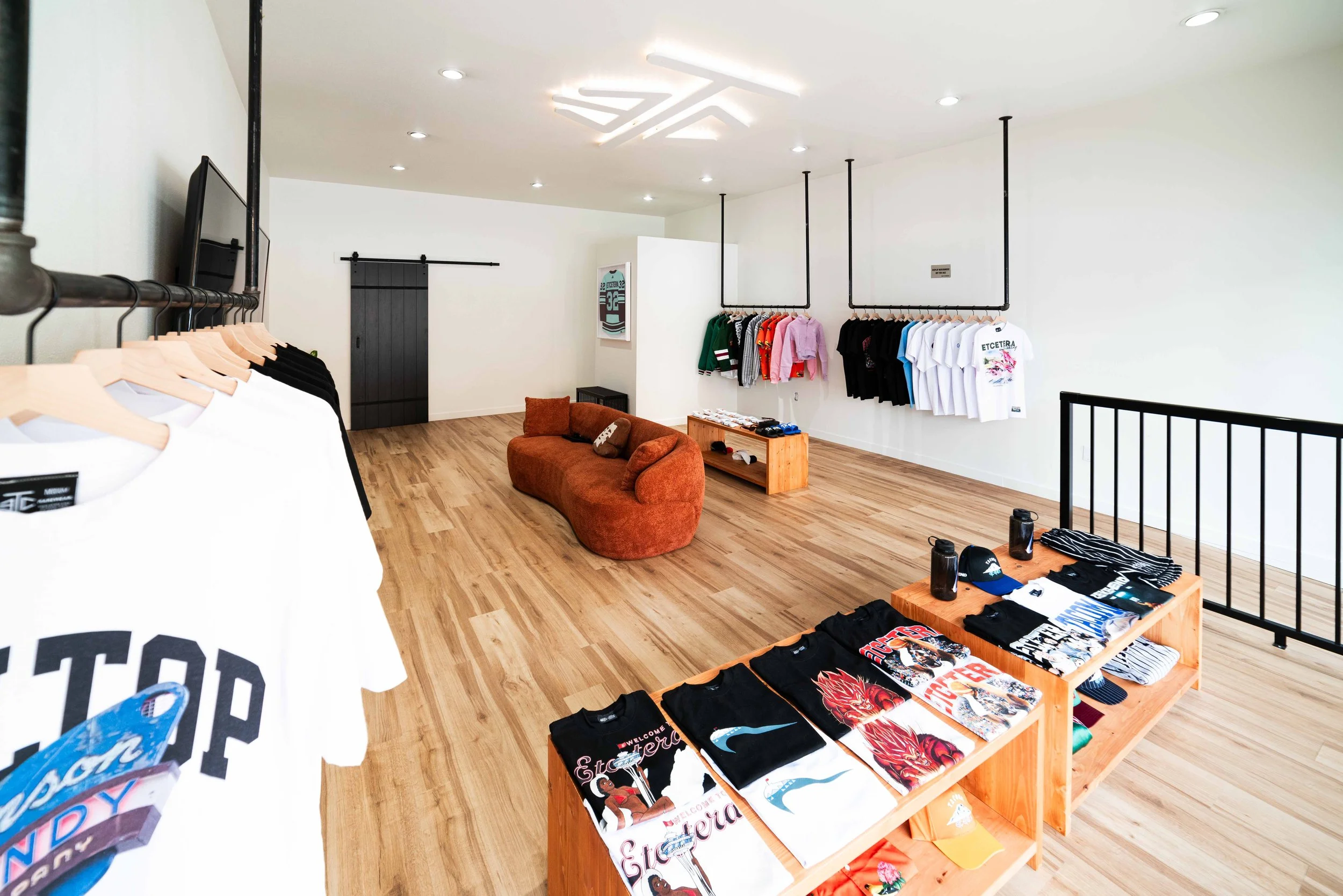 Rack of eTc tees and tops in the Tacoma shop